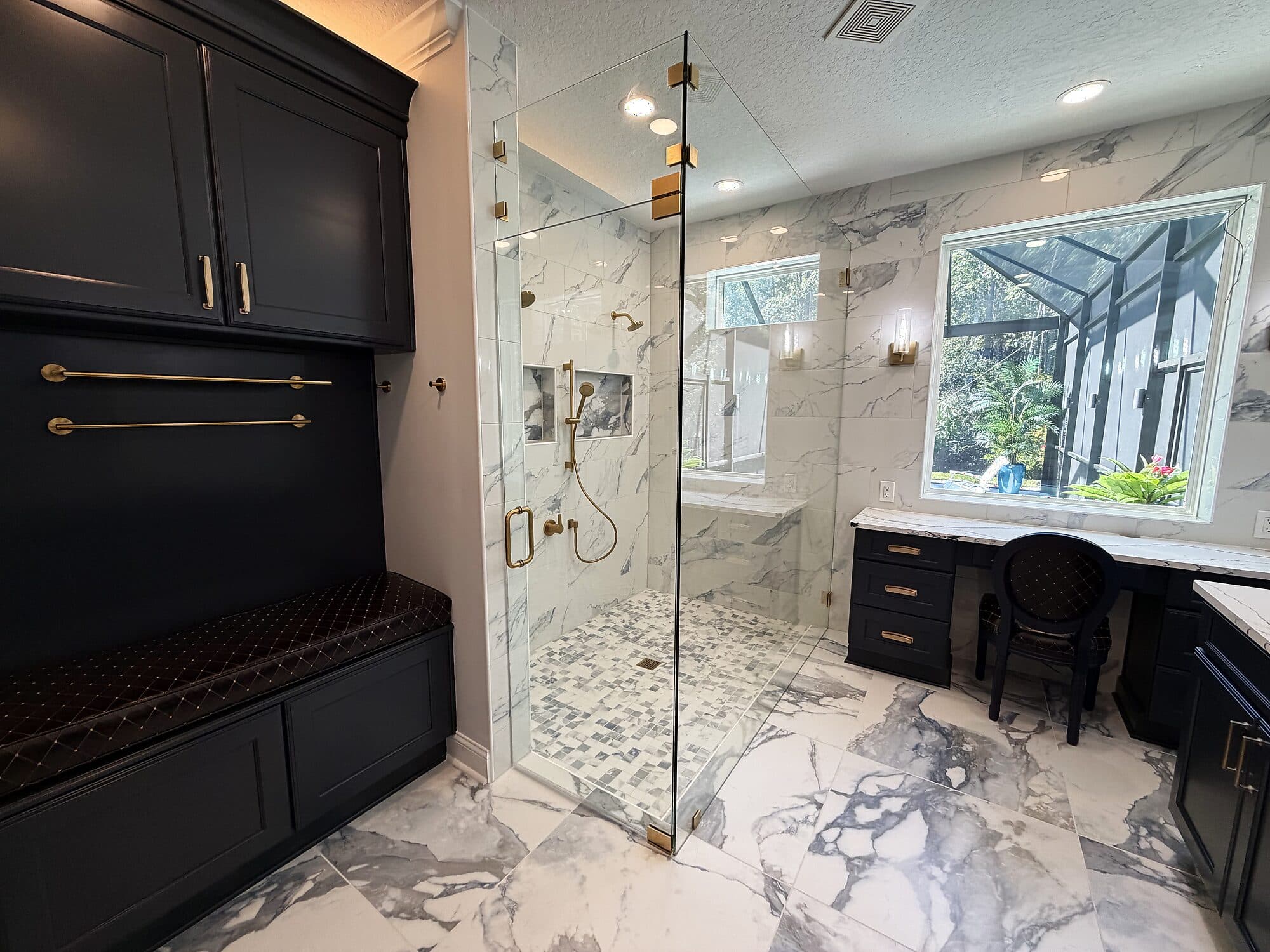Navy-and-marble bathroom after Integrity Construction Co.'s remodel in Coastal Oaks, Nocatee, Florida