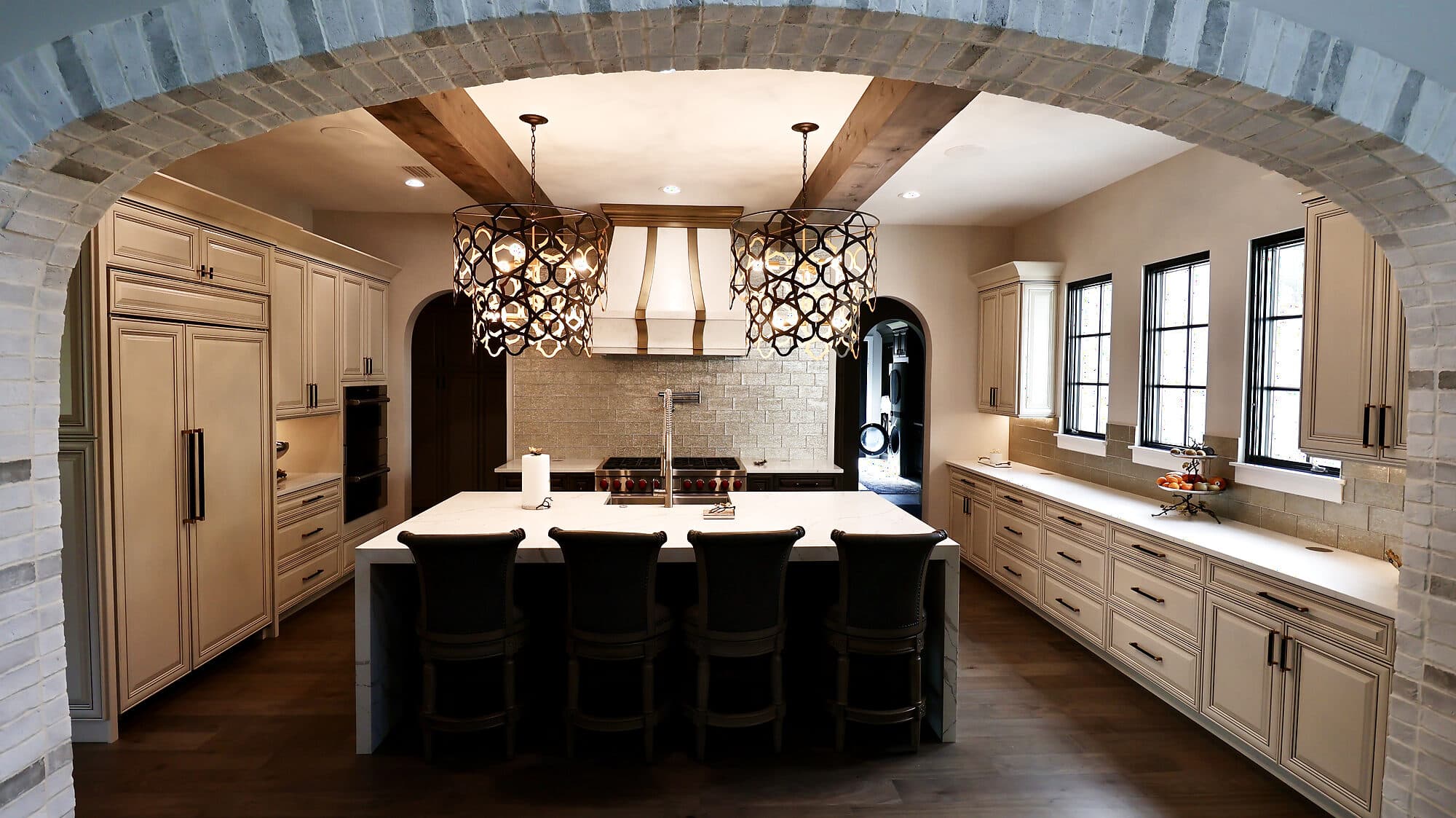 Custom kitchen with a large island, full-height cabinetry, and pendant lighting in a custom home in Nocatee, Florida