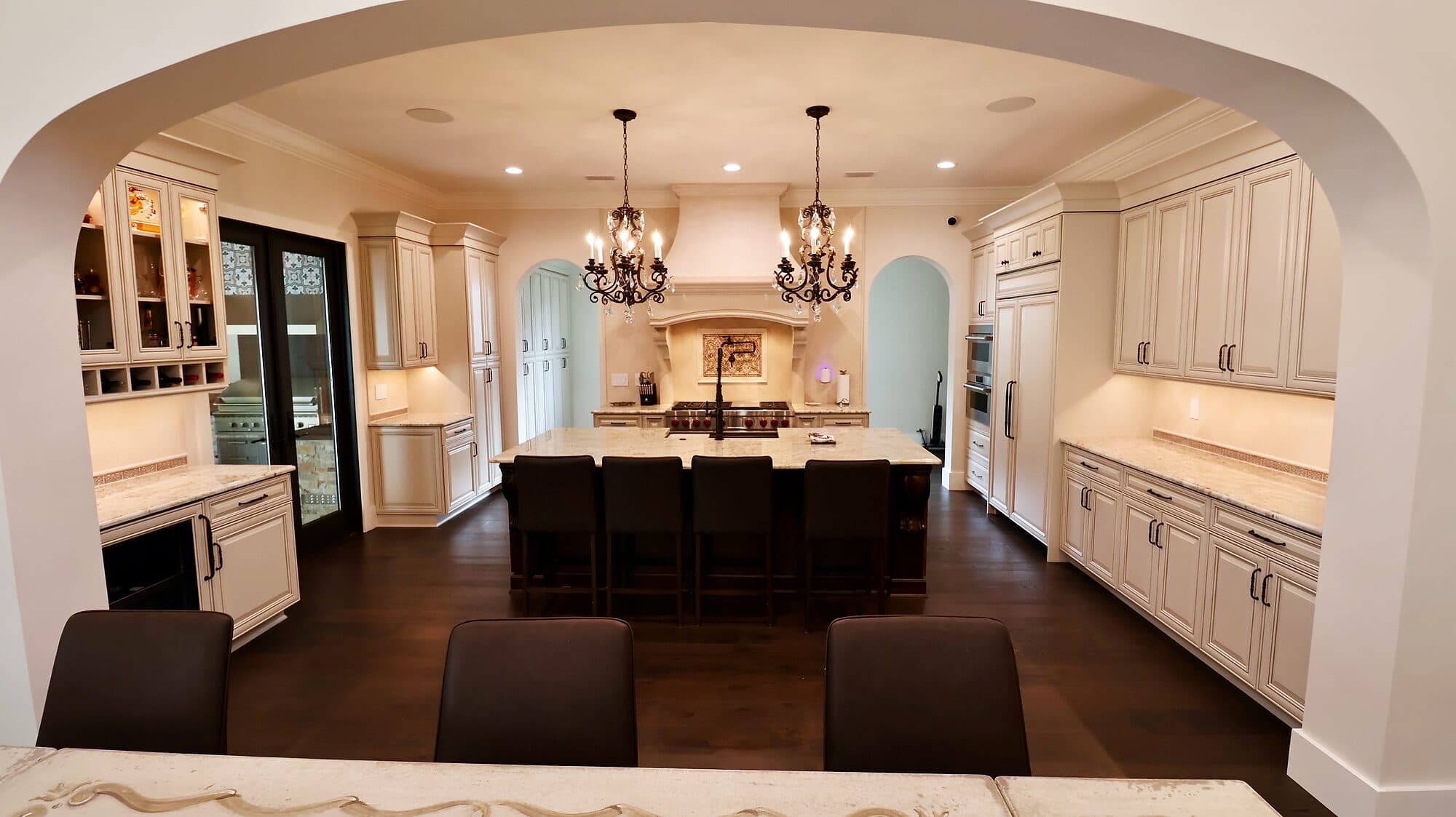 Wide view of a custom kitchen open to the living space in a custom home in Nocatee, Florida